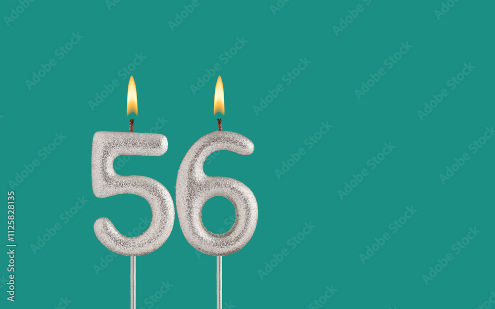 Birthday candle number 56 - Card on a green background. Birthday candle number 56 - Card on a green background.