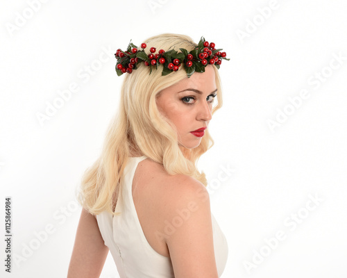 close up portrait of beautiful blonde female model wearing holly and ivy Christmas  fantasy wreath crown headdress. isolated silhouette on white studio background. photo