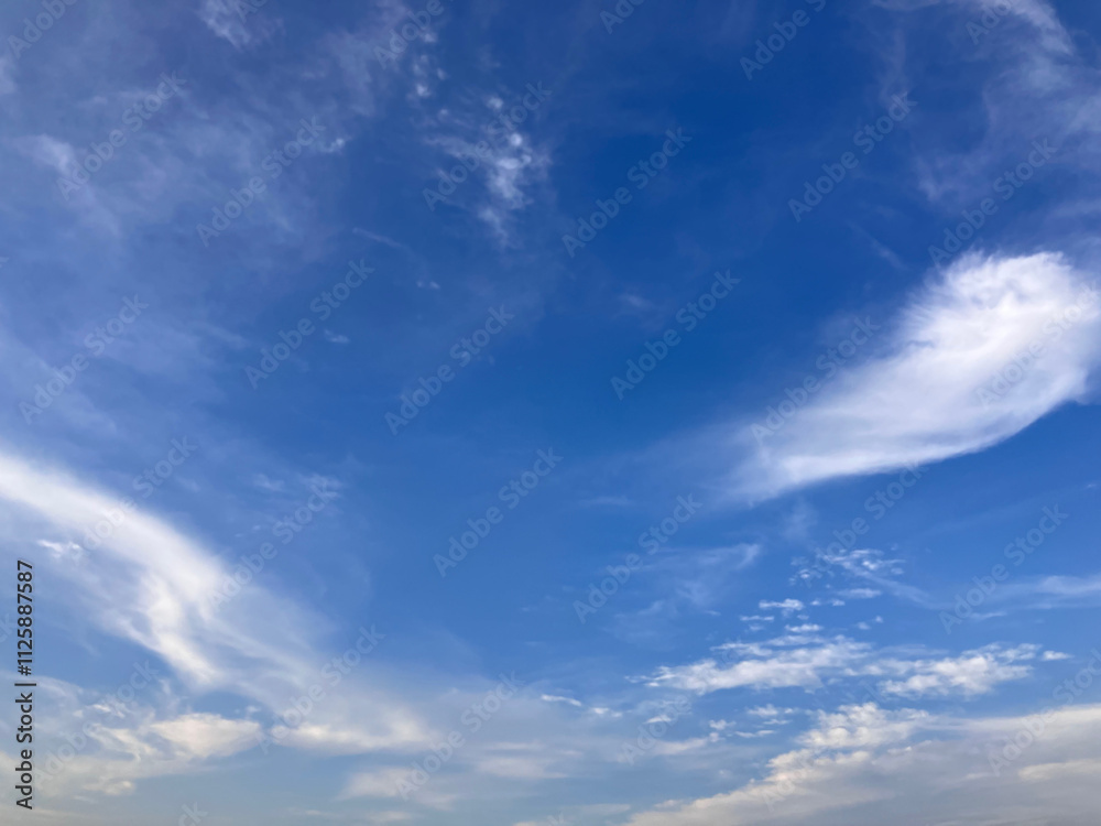 Obraz premium Pristine Blue Atmosphere with Dreamlike White Cloud Swirls Above