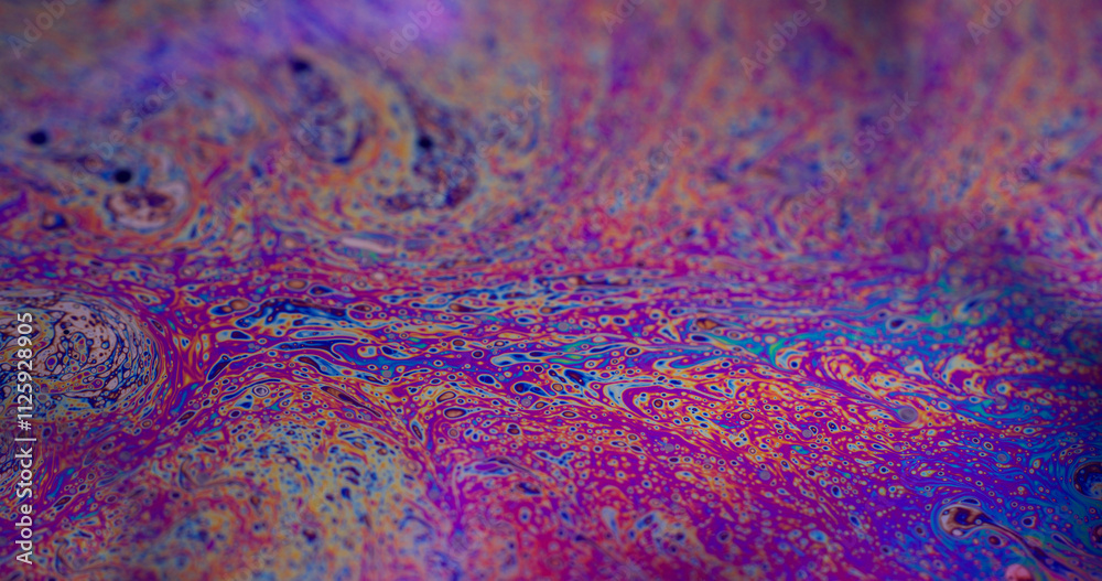 Fototapeta premium Acrylic emulsion. Bubbles wave. Defocused multicolor purple green liquid oil paint curve acrylic slick on dark black blurred light abstract art background.