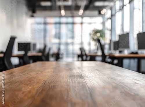 Empty wooden desk in modern office with blurred background.