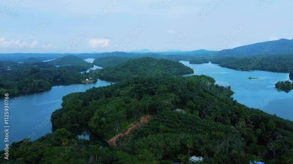 Greenish blue mountains, Areal view of a Beautiful reservoir dam in Kerala, India, Morning view of Neyyar dam, Mountains and small green islands are seen in this video Greenish blue mountains, Areal view of a Beautiful reservoir dam in Kerala, India, Morning view of Neyyar dam, Mountains and small green islands are seen in this video