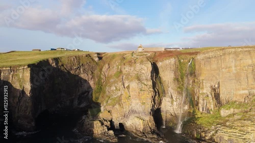 cliff edge of Whaligoe steps and hidden fall side aerial shot photo