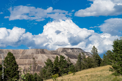 Expansive view of a terraced waste dump of processed gold ore.