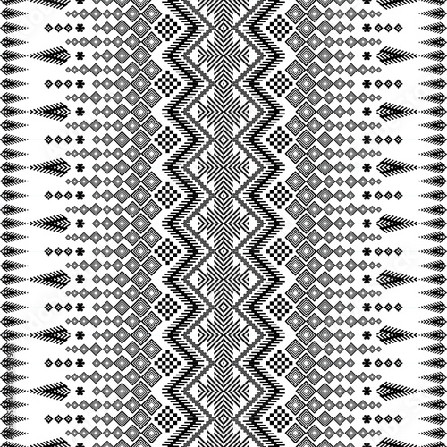 A striking black and white geometric pattern inspired by traditional ethnic art. The design features a repeating motif of diamonds, squares, and zigzags, creating a bold and graphic look.