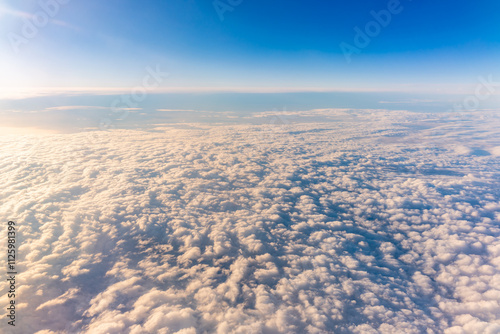 Beautiful orange and pink sunrise over the clouds, view from the plane. photo