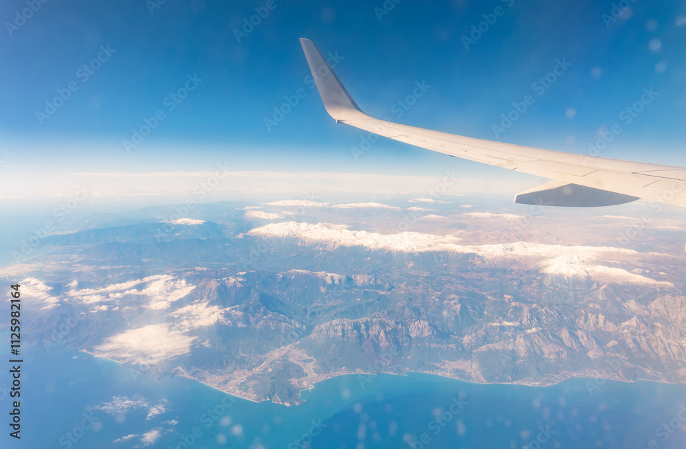 View from the airplane window of the mountains and sea resort with corals in Egypt, Sharm El Sheikh.Flight View from the airplane window of the mountains and sea resort with corals in Egypt, Sharm El Sheikh.Flight