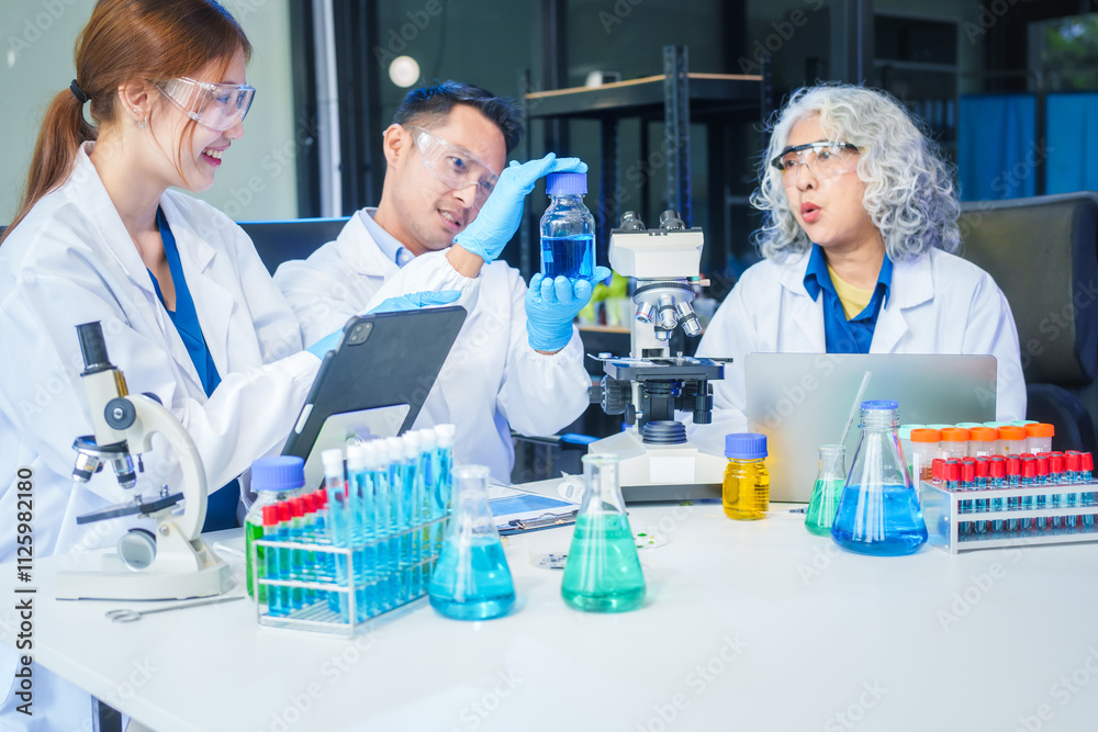 Two Asian men and women sit at a table in a laboratory, conducting research on liquids. They use microscopes, petri dishes, and test tubes filled with various chemicals for analysis Two Asian men and women sit at a table in a laboratory, conducting research on liquids. They use microscopes, petri dishes, and test tubes filled with various chemicals for analysis
