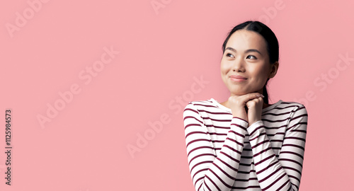 Great Offer. Happy Cute Korean Lady Looking Aside At Copy Space With Amazement, Young Asian Female Keeping Fists Near Face And Thinking About Nice Promo, Standing Over Pink Background, Panorama