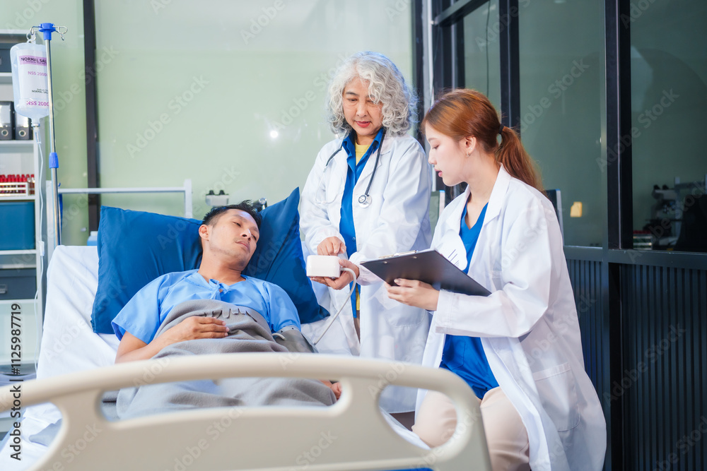 Fototapeta premium Two female doctors examine a patient lying on a hospital bed,discuss the medical chart,administer medicine,and provide encouragement, ensuring compassionate care and fostering the patient's recovery