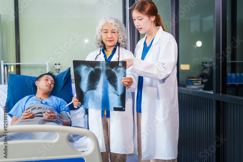 Two female doctors examine a patient lying on a hospital bed,discuss the medical chart,administer medicine,and provide encouragement, ensuring compassionate care and fostering the patient's recovery