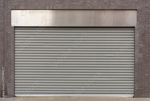Closed steel shutter door of warehouse, storage or storefront for metal door background and textured