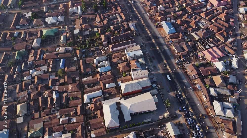 Beautiful high angle pan of neighborhoods in the outskirts of Abuja, Nigeria. The main road is slowly clogging up due to a large traffic jam Beautiful high angle pan of neighborhoods in the outskirts of Abuja, Nigeria. The main road is slowly clogging up due to a large traffic jam