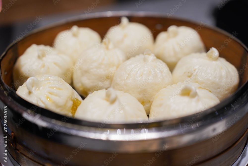 Steamed xiao long bao in bamboo steaming bowl. Chinese steamed bun. Dim sum. Chinese food