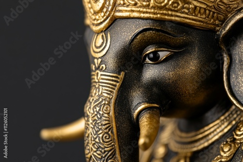 Intricate golden black elephant statue with decorative details