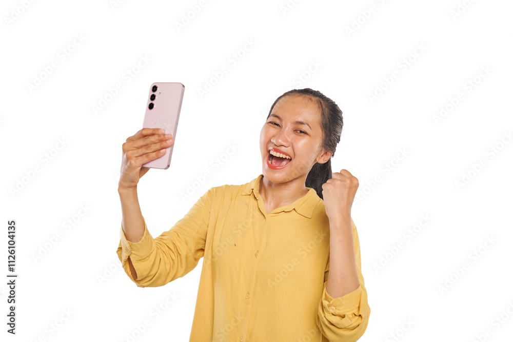 Portrait of happy Asian woman wearing yellow blouse, holding phone with raised fist Portrait of happy Asian woman wearing yellow blouse, holding phone with raised fist