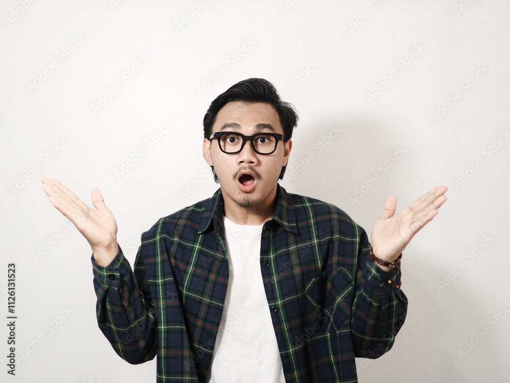 An asian man showing shocked face expression isolated white background An asian man showing shocked face expression isolated white background