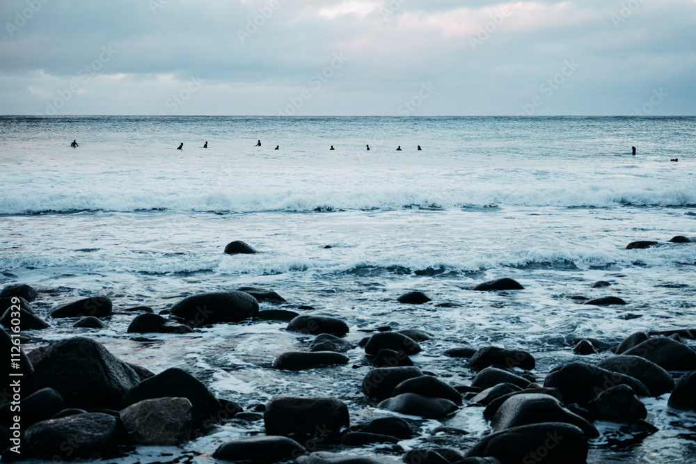 Surfers on the Horizon at Unstad Beach Lofoten Surfers on the Horizon at Unstad Beach Lofoten