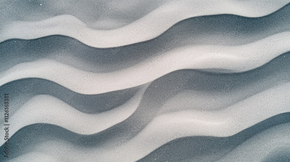 Aerial view of smooth beach sand with intricate lines and waves formed by tidal movements Aerial view of smooth beach sand with intricate lines and waves formed by tidal movements