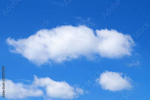 Blue sky with white clouds. The background is a clear blue sky without any clouds. A wide-angle view of the entire picture, showing vast and endless skies.