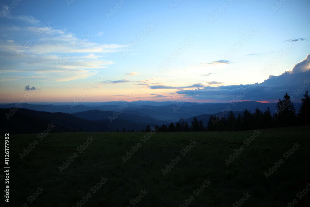 Landscape of Zywiec Beskids mountain range after sunset, view from Rysianka peak, Poland