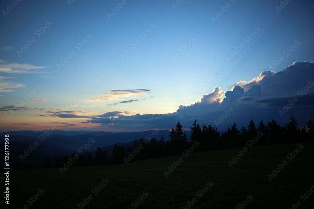 Landscape of Zywiec Beskids mountain range after sunset, view from Rysianka peak, Poland