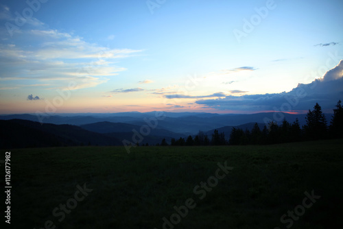 Landscape of Zywiec Beskids mountain range after sunset, view from Rysianka peak, Poland