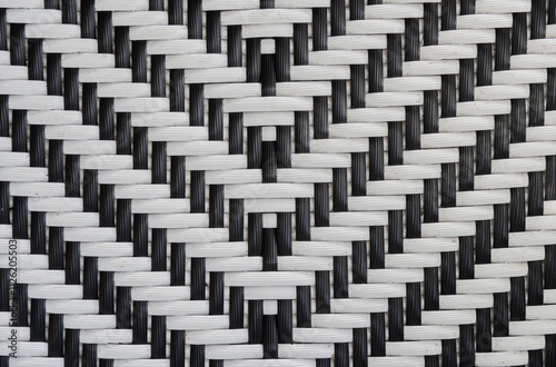 Two-tone black and white abstract weave pattern on plastic rattan