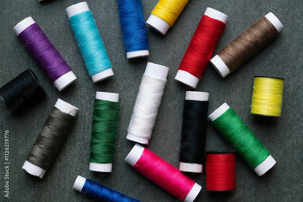 Colored thread coils on black table background, top view Colored thread coils on black table background, top view