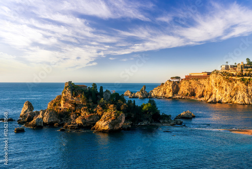 scenic sea shore view of island in ocean with waves and amazing cloudy sunset or sunrise on backgeound photo