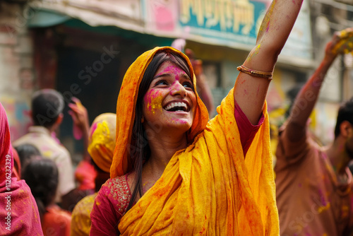 Joyful woman celebrating Holi with vibrant colors and smiles photo