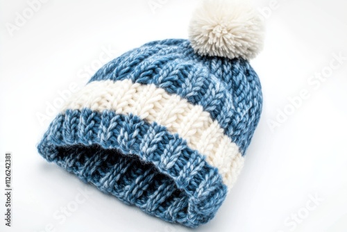 A cozy blue and white striped knitted beanie with a thick ribbed brim and a soft pom pom