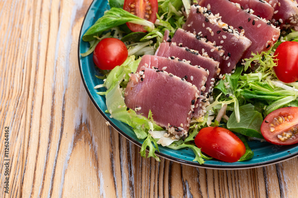 Salad with raw tuna , sesame and cherry tomatoes photography . Top view Salad with raw tuna , sesame and cherry tomatoes photography . Top view