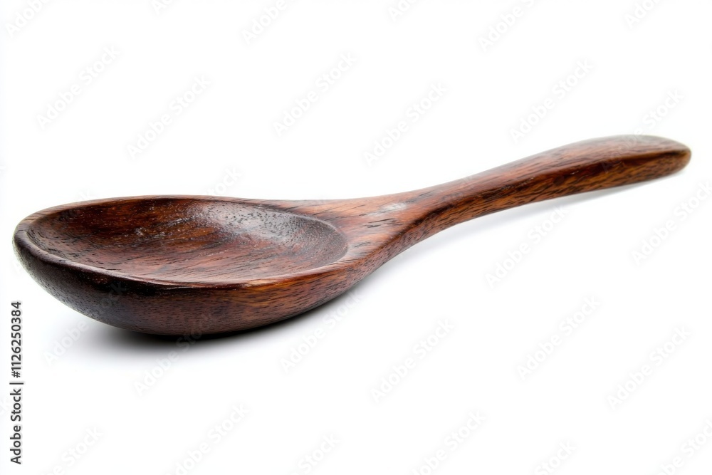 A single handcrafted wooden spoon with a smooth A single handcrafted wooden spoon with a smooth