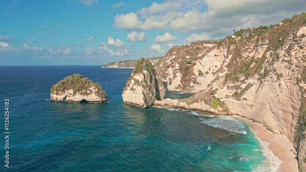Sea Cliff Rock Face On Nusa Penida Coastline, Diamond Beach In Bali, Indonesia. Aerial Drone Shot Sea Cliff Rock Face On Nusa Penida Coastline, Diamond Beach In Bali, Indonesia. Aerial Drone Shot