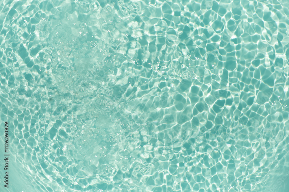 Blue water with ripples on the surface. Defocus blurred transparent blue colored clear calm water surface texture with splashes and bubbles. Water waves with shining pattern texture background. Blue water with ripples on the surface. Defocus blurred transparent blue colored clear calm water surface texture with splashes and bubbles. Water waves with shining pattern texture background.