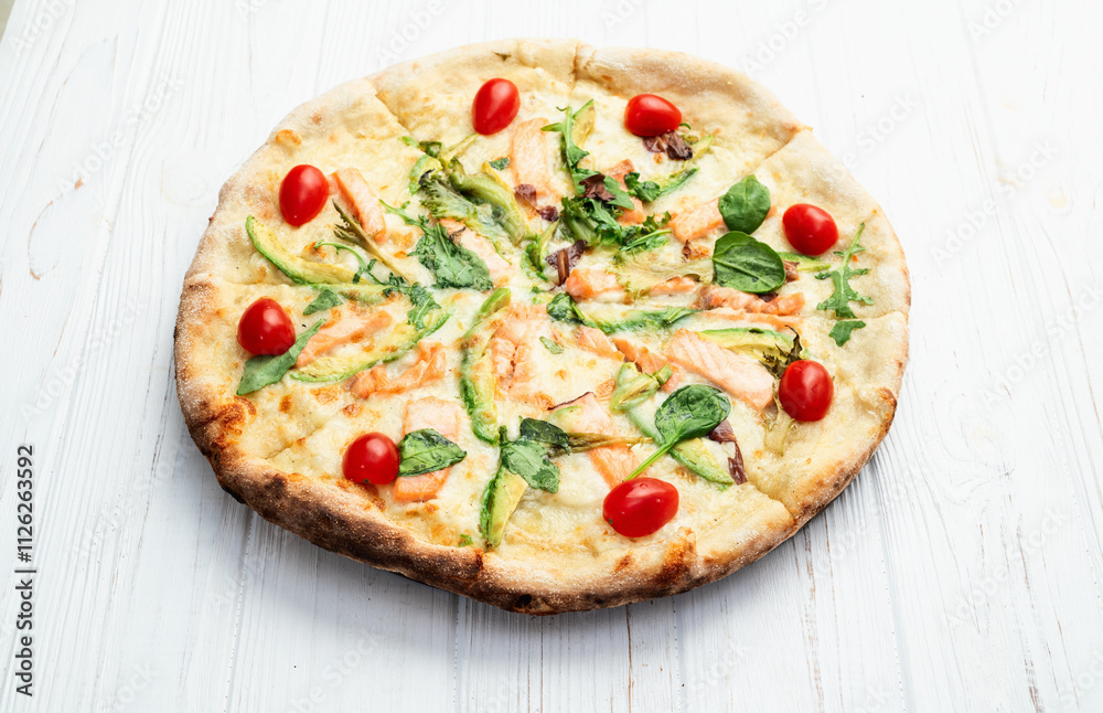 Italian pizza with avocado salmon tomatoes and mozzarella photography. top view Italian pizza with avocado salmon tomatoes and mozzarella photography. top view