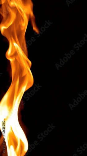 Abstract flames dancing against a stark black background, blaze