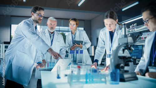 Modern Medicine Research Laboratory: Diverse Team of Smart Young Scientists Conducting an Experiment Under Senior Professor's Supervision. Advanced Microbiology Lab with High Tech Equipment