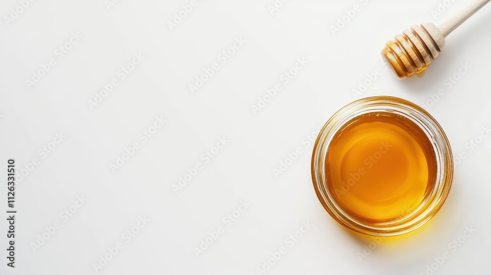A jar of honey with a honey dipper on a white background. A jar of honey with a honey dipper on a white background.