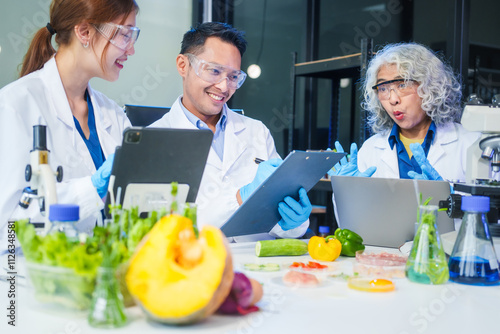 A male scientist and two women conduct plant research in a laboratory. microscopes, petri dishes,test tubes to analyze genetically modified plants, food, meat, eggs,vegetables for nutritional value