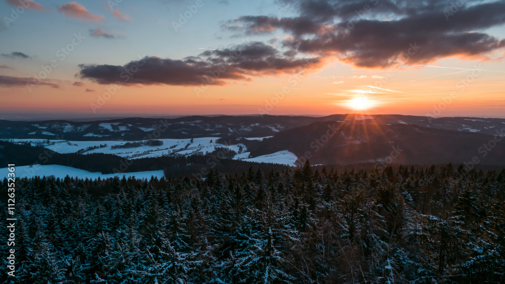 Obraz premium Colorful sunset over the Czech countryside. View from the Teplice-Adršpašské rocks of the Giant Mountains and the surrounding hills.