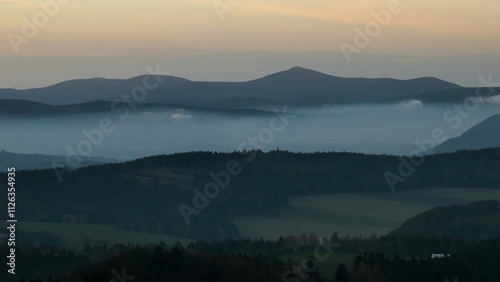 Colorful sunset over the Czech countryside. View from the Teplice-Adršpašské rocks of the Giant Mountains and the surrounding hills.