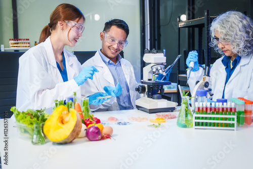 A male scientist and two women conduct plant research in a laboratory. microscopes, petri dishes,test tubes to analyze genetically modified plants, food, meat, eggs,vegetables for nutritional value