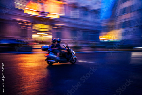 A Couple Rides a Scooter Through the Streets of Rome During Sunset