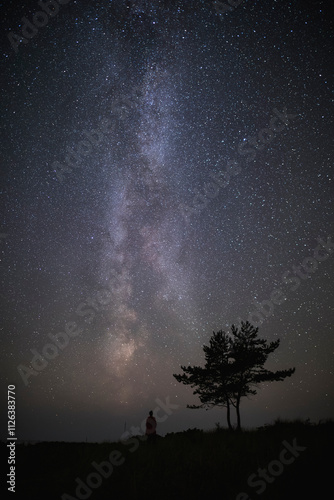 A lonely person looks up at the night sky