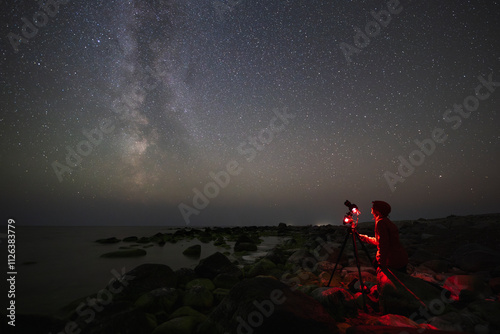 A person takes a photo of the night sky showing the Milky Way and 