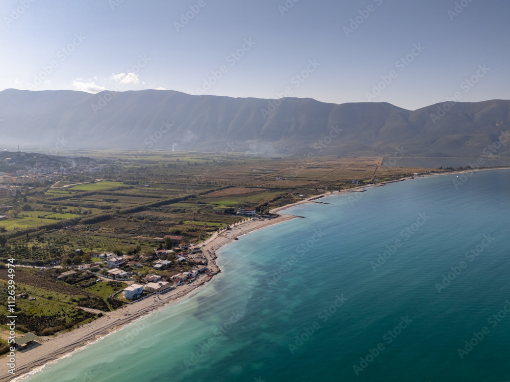 Obraz premium Aerial drone view of the coastline and beach in Orikum, Albania.