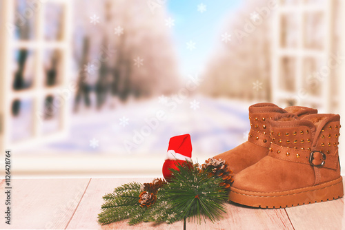 Christmas background. Table top christmas winter decoration background with an pair of winter boots over beautiful abstract winter xmas background. Card concept.