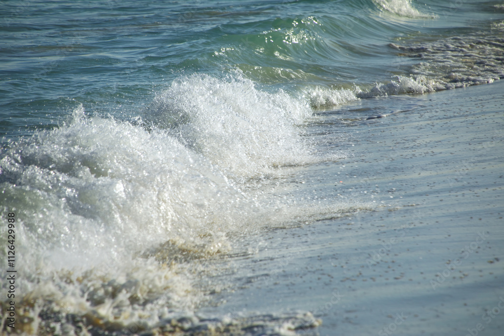 Fototapeta premium Close-up of surf on sandy beach
